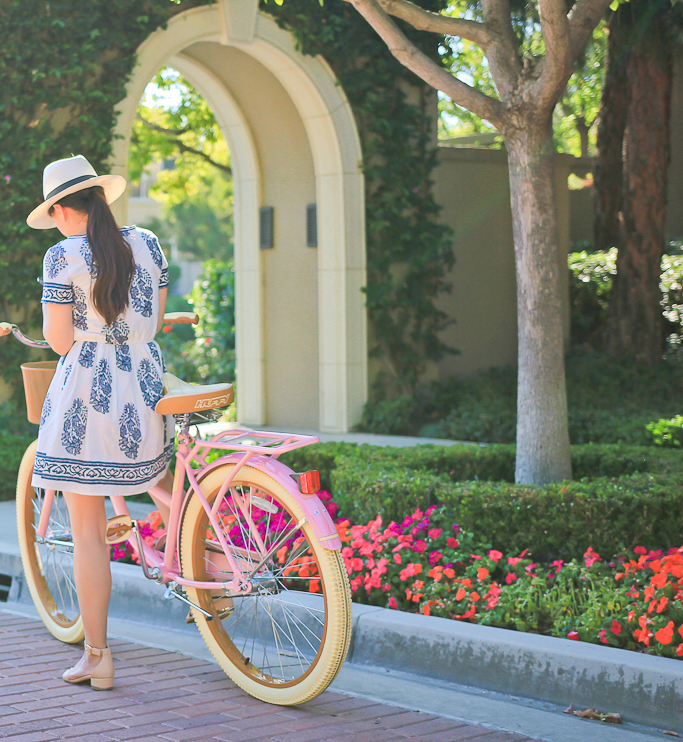 pink cruiser bike panama hat blue floral print dress sandals summer outfit