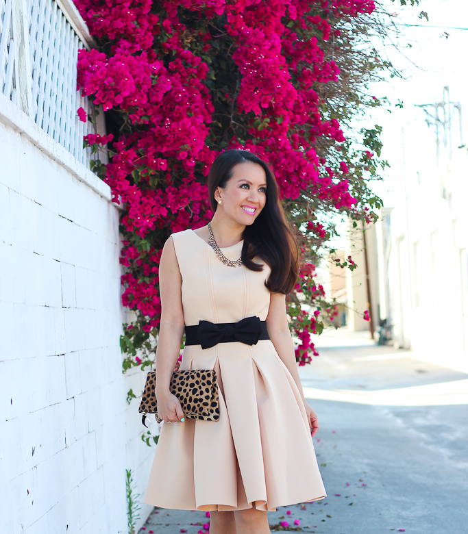 Anthropologie peche bib crystal necklace, black bow belt, Chicwish New Favored Pleated Dress in Nude, Clare V leopard foldover clutch, J.Crew black patent pumps