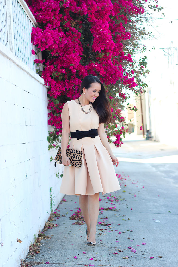 Anthropologie peche bib crystal necklace, black bow belt, Chicwish New Favored Pleated Dress in Nude, Clare V leopard foldover clutch, J.Crew black patent pumps