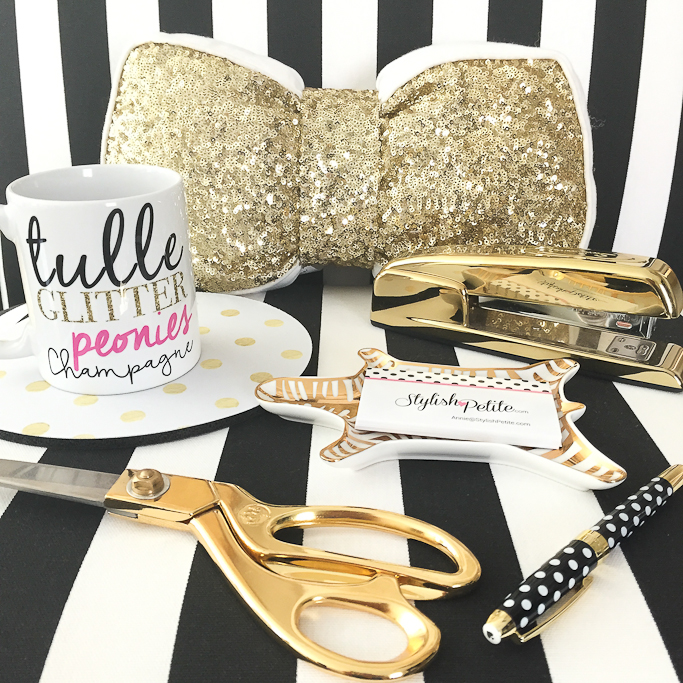 Tulle Glitter peonies champagne mug, gold sequin bow pillow, gold scissors, gold stapler, Kate Spade polka dot pen, Jonathan Adler Metallic Porcelain Zebra Dish Striped accent chair