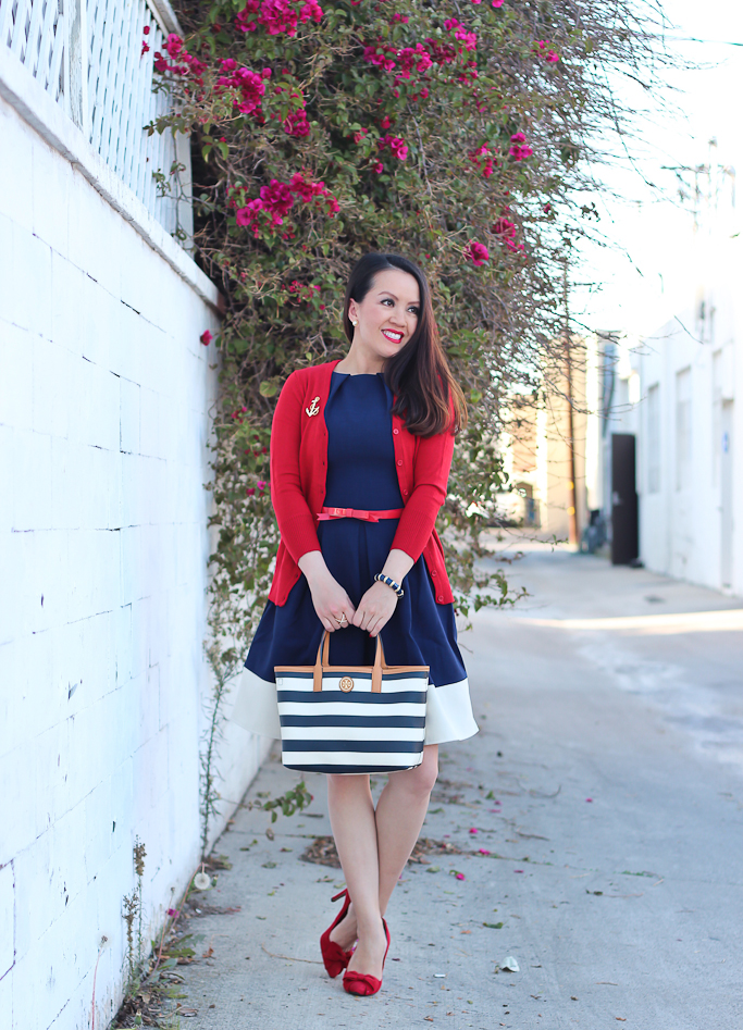 Anchor brooch, Halogen red bow suede pumps, Modcloth Charter School Cardigan in Red, Modcloth Luck Be a Lady Dress in Navy Contrast, nautical outfit, Red leather bow belt, Tory Burch striped tote