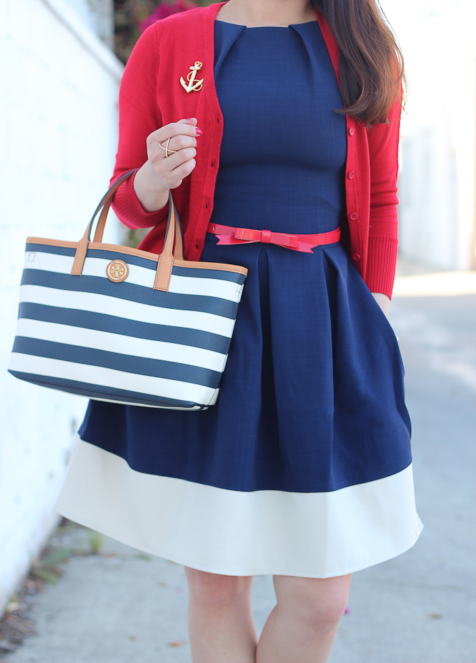Anchor brooch, Halogen red bow suede pumps, Modcloth Charter School Cardigan in Red, Modcloth Luck Be a Lady Dress in Navy Contrast, nautical outfit, Red leather bow belt, Tory Burch striped tote