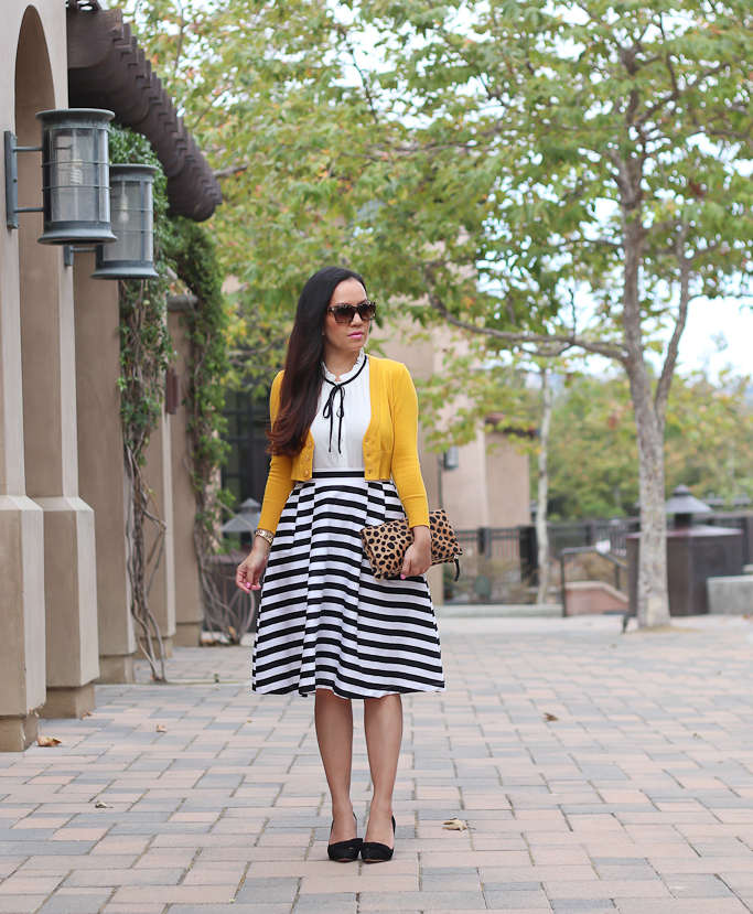 Ann Taylor odette bow pumps, Clare V leopard foldover clutch, Modcloth dusk and stunner skirt, Modcloth refreshing routine top, striped flare skirt, The Dream of the Crop Cardigan in Honey