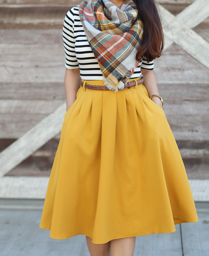mustard pleated skirt plaid blanket scarf striped top classy winter outfit