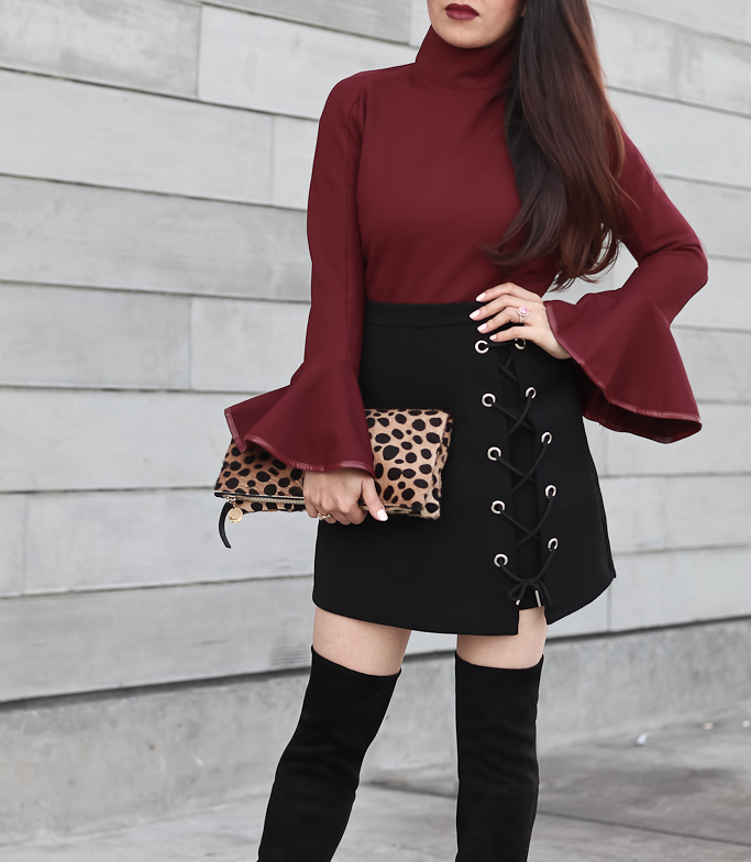 maroon top and black skirt
