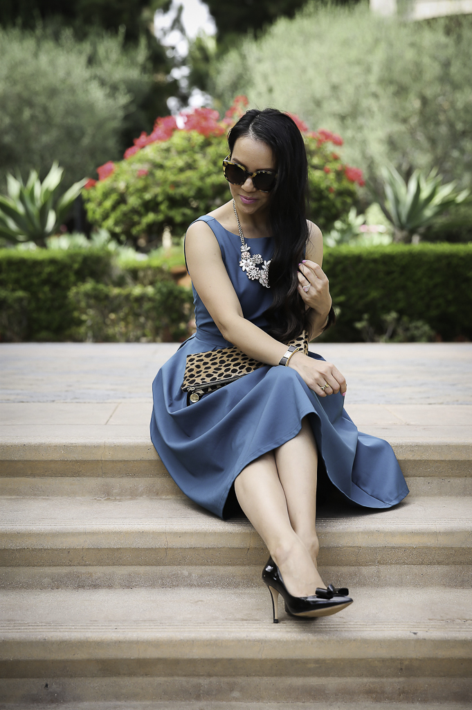 bow dress holiday outfit idea bow pumps leopard clutch