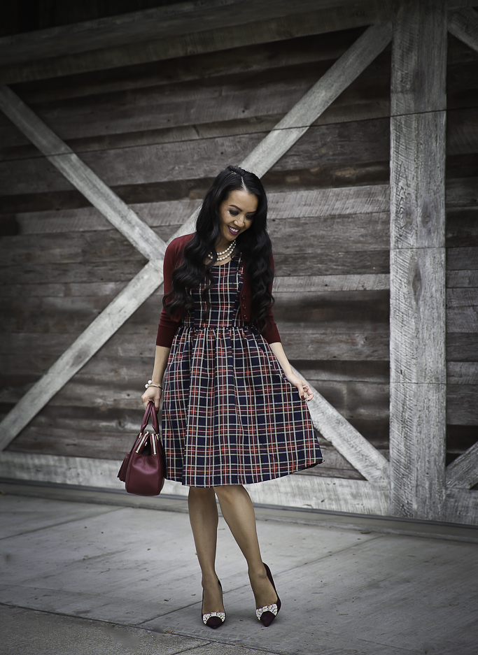 holiday outfit idea plaid dress with pockets cropped cardigan bow pumps chunky knit hat