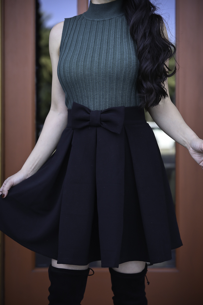 black bow skirt green turtleneck over the knee boots holiday outfit idea