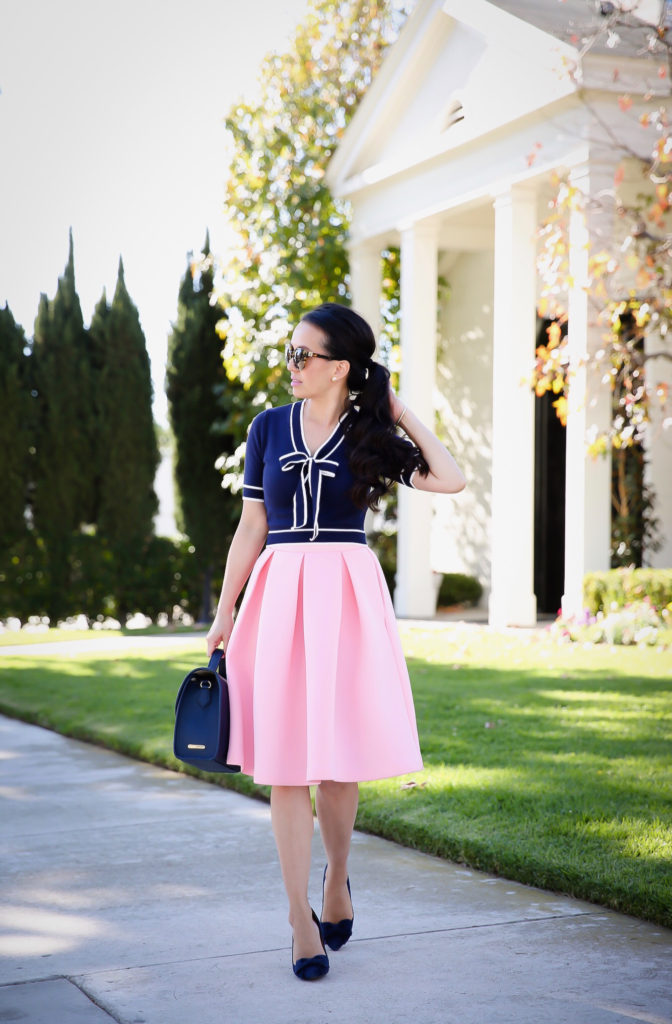 pink pleated skirt navy bow cropped sweater work outfit