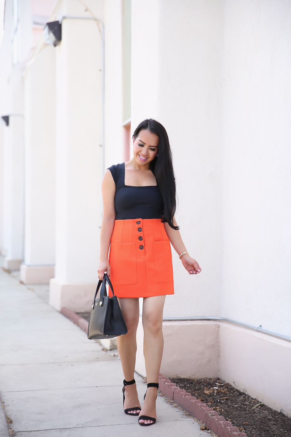 black bodysuit orange pocket miniskirt black sandals 