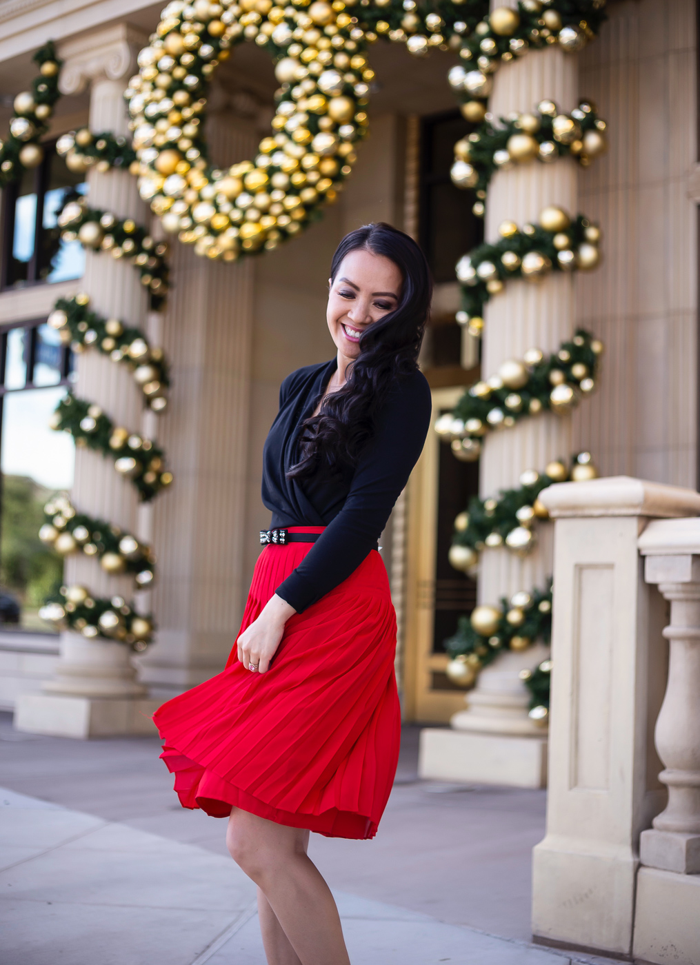 red pleated skirt bow belt wrap top bow pumps holiday outfit