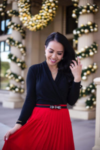 red pleated skirt bow belt wrap top bow pumps holiday outfit