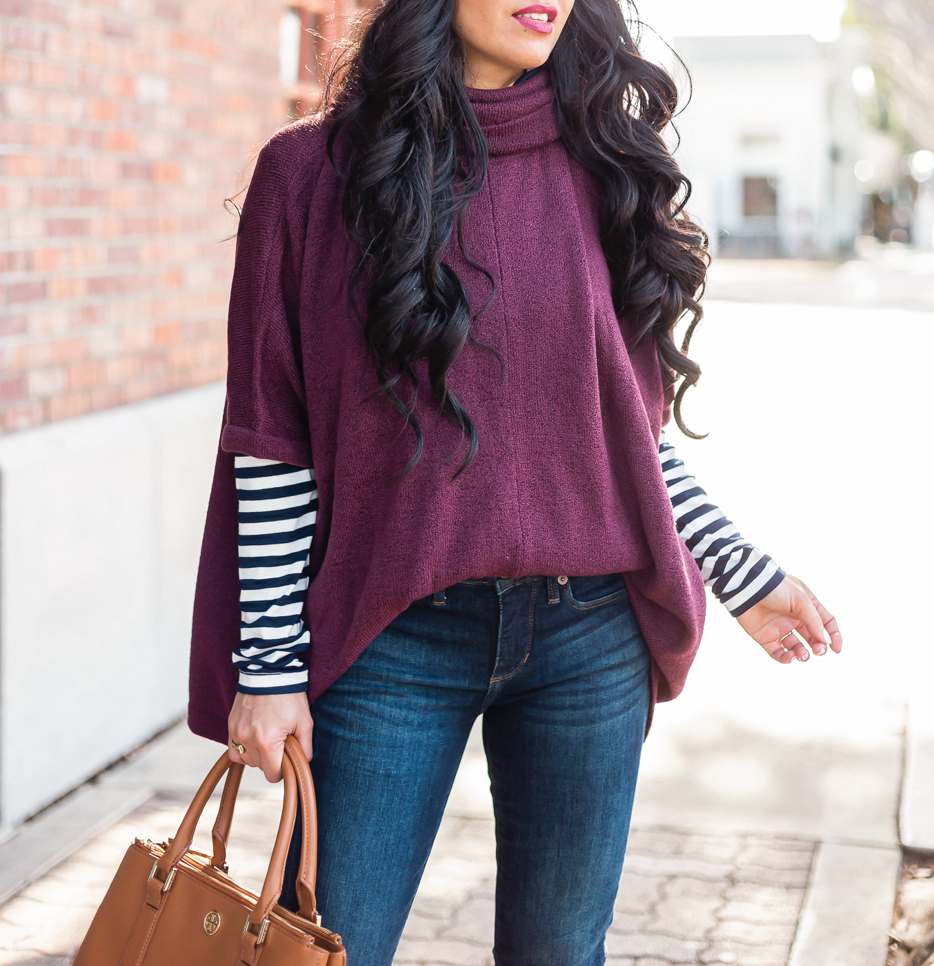 burgundy sweater poncho striped turtleneck dark denim jeans winter outfit