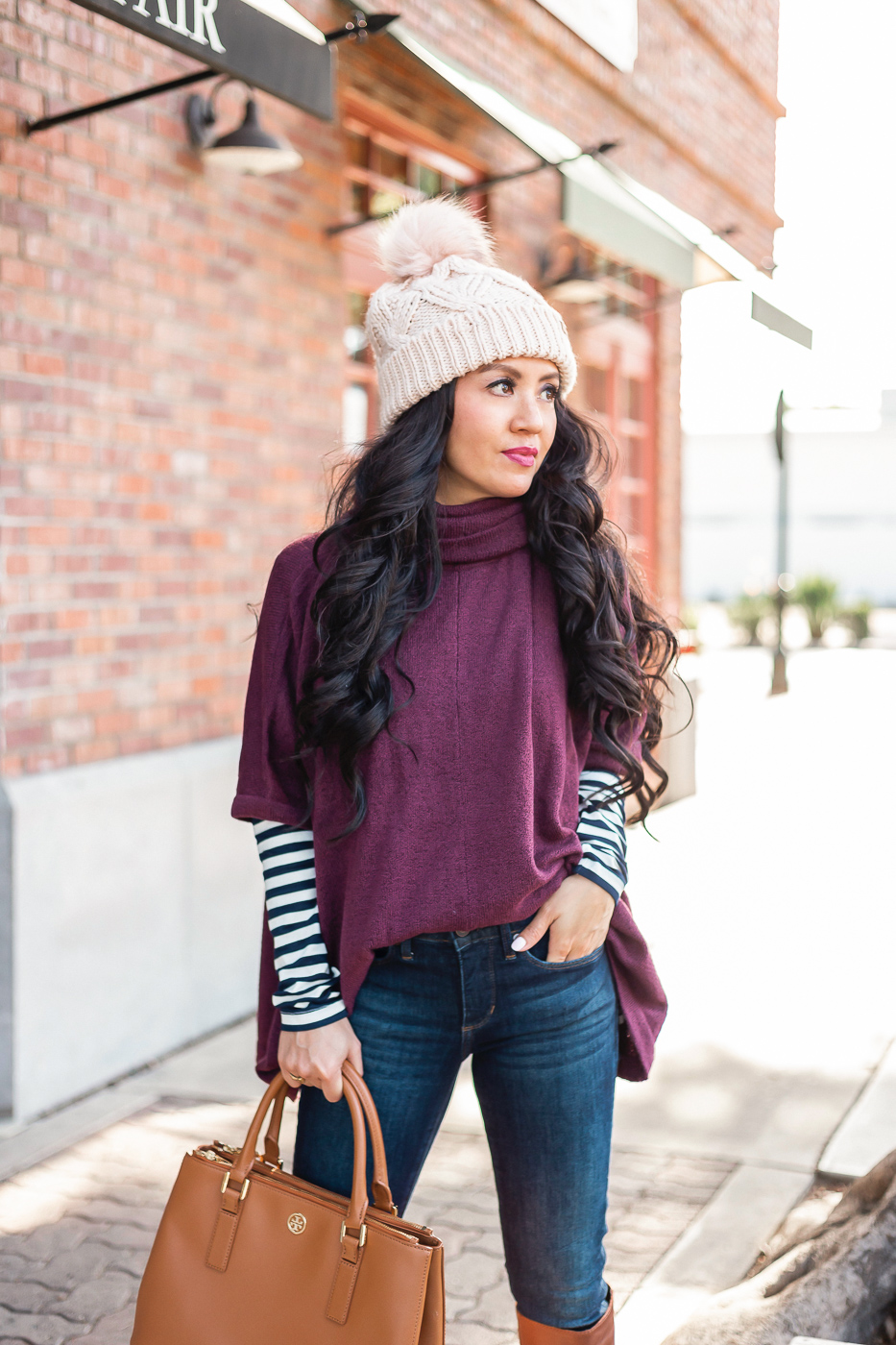 burgundy sweater poncho striped turtleneck dark denim jeans winter outfit