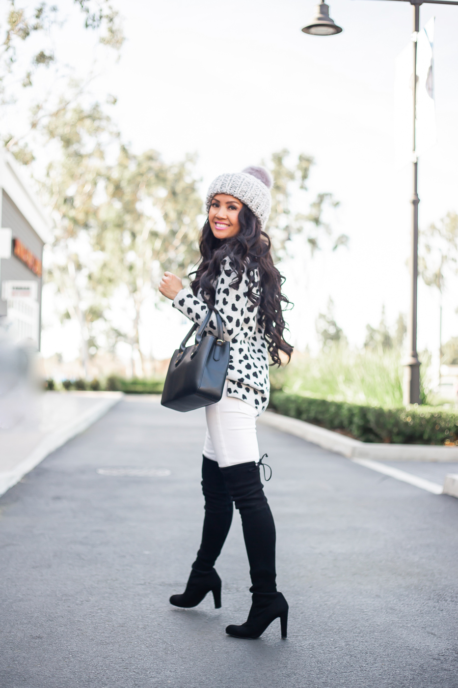 heart sweater white jeans black over the knee boots beanie winter outfit