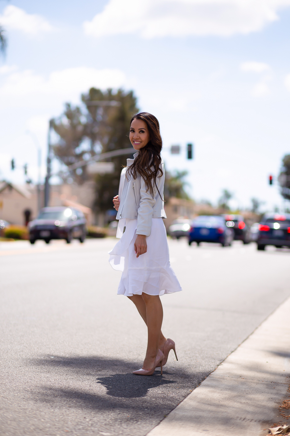 white linen wrap ruffle dress vegan leather moto jacket spring outfit